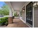 Inviting covered front porch with brick flooring, offers a welcoming entrance with stylish lighting fixtures at 998 Regal Hills Ln, Mableton, GA 30126
