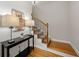 Stairway with wood treads, iron railings and adjacent console table at 998 Regal Hills Ln, Mableton, GA 30126
