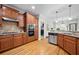 Well-equipped kitchen featuring stainless steel appliances, granite countertops, and wood cabinetry at 998 Regal Hills Ln, Mableton, GA 30126