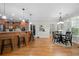 Bright kitchen and dining area with wooden floors, cabinets, stainless appliances, and pendant lighting at 998 Regal Hills Ln, Mableton, GA 30126
