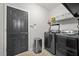Laundry room with modern washer and dryer, shelving and a door at 998 Regal Hills Ln, Mableton, GA 30126