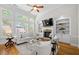Bright living room with built-in bookshelves, a fireplace, and large windows at 998 Regal Hills Ln, Mableton, GA 30126