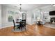 A living room and breakfast area featuring hardwood floors, many windows and a fireplace at 998 Regal Hills Ln, Mableton, GA 30126