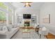 Comfortable living room featuring a fireplace, built-in shelving, and large windows for ample natural light at 998 Regal Hills Ln, Mableton, GA 30126