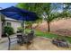 Outdoor patio with table, chairs, umbrella, and fire pit in backyard at 998 Regal Hills Ln, Mableton, GA 30126
