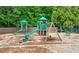 Community playground with slides, swings, and climbing structures on a wood chip surface at 998 Regal Hills Ln, Mableton, GA 30126
