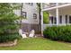 Serene backyard featuring a small stone-edged garden and a set of two white Adirondack chairs at 207 Wesley Ne Ave, Atlanta, GA 30307