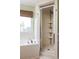 Bright bathroom featuring a tub with chrome fixtures and a separate glass shower enclosure with corner shelving at 207 Wesley Ne Ave, Atlanta, GA 30307