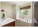 Modern bathroom featuring a soaking tub, double vanity, and natural light at 207 Wesley Ne Ave, Atlanta, GA 30307