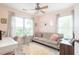 This bedroom features a seating area, a plush rug, and natural light streaming in from the two large windows at 207 Wesley Ne Ave, Atlanta, GA 30307