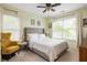 Well-lit bedroom with a gray headboard, an accent chair, two windows, and neutral decor for a peaceful atmosphere at 207 Wesley Ne Ave, Atlanta, GA 30307