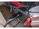 Close-up of a Tesla car charging station plugged into a black car, highlighting modern convenience and technology at 207 Wesley Ne Ave, Atlanta, GA 30307