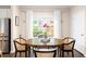 Sunlit dining area features a round table, wood floors, and a view of the outside at 207 Wesley Ne Ave, Atlanta, GA 30307