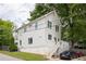 Charming two-story home with white siding, a backyard deck, well-kept lawn, and driveway with two parked cars at 207 Wesley Ne Ave, Atlanta, GA 30307