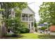Charming two-story home with double porches and a beautifully landscaped front yard with seating at 207 Wesley Ne Ave, Atlanta, GA 30307