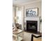 Close-up of a fireplace featuring black tile, a white mantle, and stylish decor at 207 Wesley Ne Ave, Atlanta, GA 30307