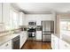 Stylish kitchen features modern appliances, granite countertops, and an adjacent dining area at 207 Wesley Ne Ave, Atlanta, GA 30307