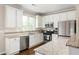 Modern kitchen features stainless steel appliances, white cabinets, and granite countertops at 207 Wesley Ne Ave, Atlanta, GA 30307