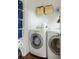 Well-organized laundry room featuring modern washer and dryer, shelving for storage, and laminate wood flooring at 207 Wesley Ne Ave, Atlanta, GA 30307