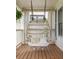 Inviting porch with a hanging swing chair, offering a relaxing outdoor space at 207 Wesley Ne Ave, Atlanta, GA 30307