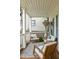 Covered porch showcasing cozy seating with patterned rug and white railings at 207 Wesley Ne Ave, Atlanta, GA 30307