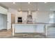 Gourmet kitchen with white cabinets, stainless steel appliances, island, pendant lighting, and pantry at 242 Linford Dr, Locust Grove, GA 30248