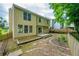 An exterior shot of the backyard featuring a fenced-in yard and small patio perfect for entertaining at 3454 Benthollow Ln, Duluth, GA 30096