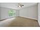 Spacious bedroom featuring plush carpeting, ample natural light from a window, and neutral walls at 3454 Benthollow Ln, Duluth, GA 30096