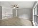 Well-lit carpeted bedroom with a ceiling fan and a large window at 3454 Benthollow Ln, Duluth, GA 30096