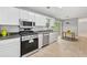 Well-equipped kitchen featuring stainless steel appliances, tile floors, and an eat-in area at 3454 Benthollow Ln, Duluth, GA 30096