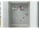 A spacious laundry room featuring open shelving, white cabinets, and convenient utility connections at 3454 Benthollow Ln, Duluth, GA 30096