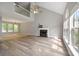 Open-concept living room boasts lots of natural light and a charming fireplace at 3454 Benthollow Ln, Duluth, GA 30096