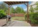 Private backyard featuring a grill, patio, and lush greenery for outdoor enjoyment at 3949 Glenview Club Ln, Duluth, GA 30097