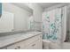 Bright bathroom featuring large mirror, white vanity, quartz counter and bathtub at 3949 Glenview Club Ln, Duluth, GA 30097