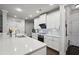 Well-lit kitchen features white cabinets, stainless appliances and stone countertops at 3949 Glenview Club Ln, Duluth, GA 30097