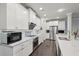 Bright kitchen boasts white cabinets, stainless steel appliances, and quartz countertops at 3949 Glenview Club Ln, Duluth, GA 30097