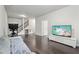 Living room with hardwood floor, TV, sofa, and stairs at 3949 Glenview Club Ln, Duluth, GA 30097