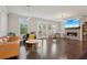 Spacious living room with hardwood floors, a fireplace, a large TV, and lots of natural light at 3949 Glenview Club Ln, Duluth, GA 30097