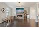 Bright living room featuring hardwood floors, a fireplace, and a dining area at 3949 Glenview Club Ln, Duluth, GA 30097