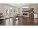Bright living room featuring hardwood floors, a fireplace, french doors to the outside, and a dining area at 3949 Glenview Club Ln, Duluth, GA 30097