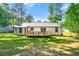 Spacious backyard view of home featuring a wooden deck, lush grass and partial view of the home at 4043 Chedworth Way, Stone Mountain, GA 30083