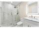 Sleek bathroom with a glass shower, tiled floors, and vanity with a lighted mirror at 4043 Chedworth Way, Stone Mountain, GA 30083