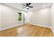 Bright bedroom with hardwood floors, ceiling fan, and window providing natural light at 4043 Chedworth Way, Stone Mountain, GA 30083
