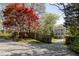Landscaped backyard with a privacy fence and an eye-catching red maple tree at 513 Boulevard Se, Atlanta, GA 30312