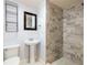 Contemporary bathroom with marble-tiled shower, pedestal sink, and modern fixtures creating a stylish space at 513 Boulevard Se, Atlanta, GA 30312