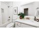 Well-lit bathroom features a tub with shower, toilet, and a vanity with white countertop and bronze fixtures at 513 Boulevard Se, Atlanta, GA 30312