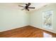 Cozy bedroom with hardwood floors, neutral paint, and a ceiling fan provides a comfortable and simple space at 513 Boulevard Se, Atlanta, GA 30312