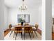 Bright dining room featuring modern light fixture, stylish wooden table and decorative art piece at 513 Boulevard Se, Atlanta, GA 30312