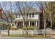 Charming two-story home featuring a welcoming front porch, complemented by a white picket fence and mature trees at 513 Boulevard Se, Atlanta, GA 30312