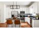 Well-lit kitchen featuring white cabinetry, stainless steel appliances, and a functional center island at 513 Boulevard Se, Atlanta, GA 30312